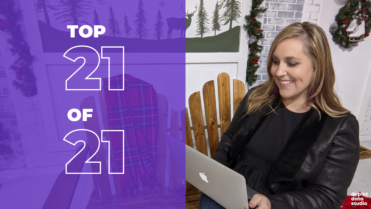 Ann K. Emery is sitting on a bench and working on her laptop.