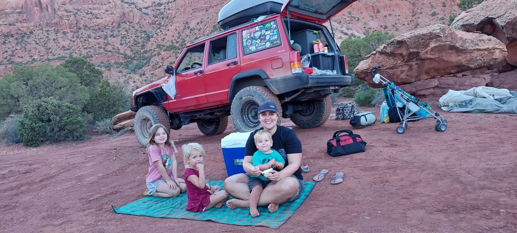 Ann K. Emery having a picnic with her kids while camping.