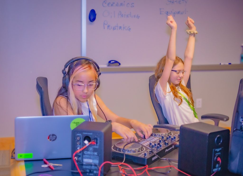 Two young girls making music