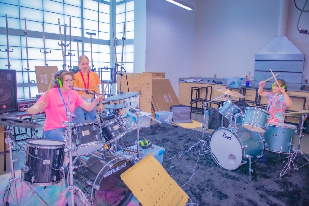 Young children playing instruments