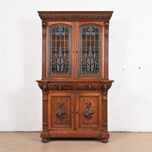 Antique French Renaissance Revival Carved Oak Breakfront Bookcase or Bar Cabinet With Stained Glass Doors