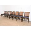 Baker Furniture French Regency Louis XVI Ebonized and Gold Gilt Cane Back Dining Chairs, Set of Eight