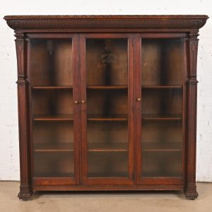 R. J. Horner Style American Empire Carved Oak Glass Front Triple Bookcase Cabinet, Circa 1890