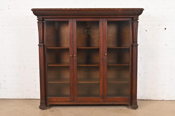 R. J. Horner Style American Empire Carved Oak Glass Front Triple Bookcase Cabinet, Circa 1890