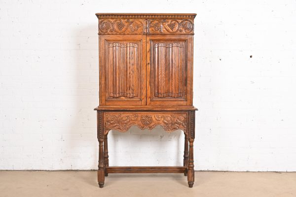 English Jacobean Carved Oak Bookcase or Bar Cabinet by Irwin, Circa 1920s