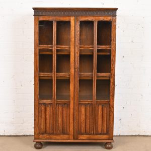 Antique English Tudor Carved Oak Glass Front Bookcase Cabinet, Circa 1920s