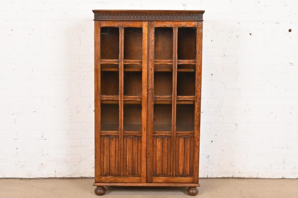 Antique English Tudor Carved Oak Glass Front Bookcase Cabinet, Circa 1920s