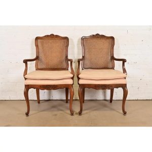 Baker Furniture Style French Provincial Louis XV Carved Walnut and Cane Back Armchairs, Pair