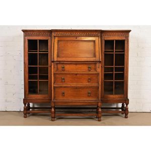 Antique English Jacobean Carved Oak Glass Front Double Bookcase With Bureau and Drop Front Secretary Desk, Circa 1920s