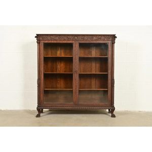 R. J. Horner Style Victorian Oak Double Bookcase With Carved Lion Heads and Paw Feet, Circa 1890s