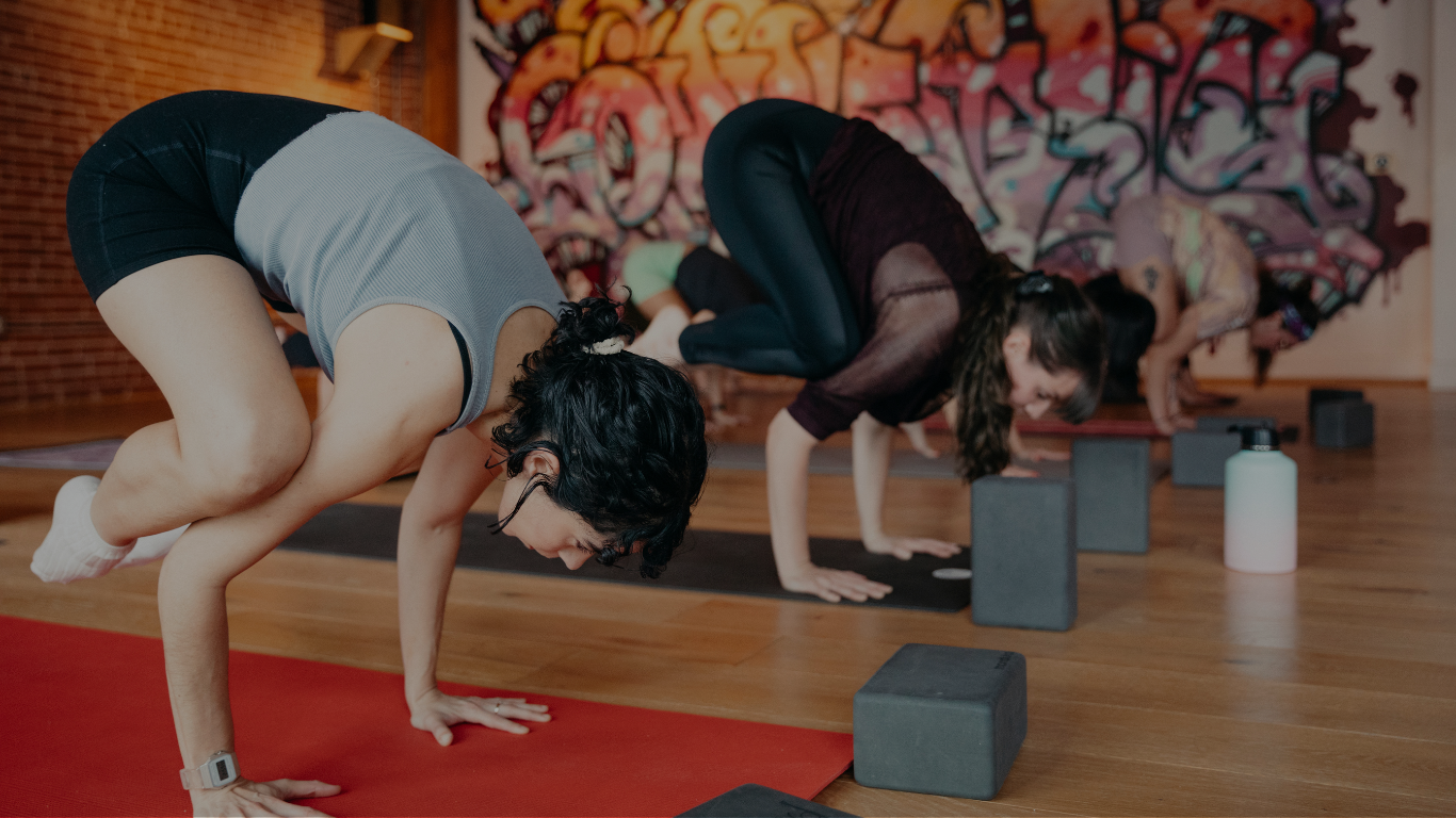 yoga students balancing in crow pose in echo park la
